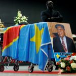 a security guard stands next to the coffin of democratic republic of congo's late veteran opposition leader etienne tshisekedi during a ceremony in brussels